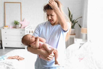 Young woman suffering from postnatal depression  at home