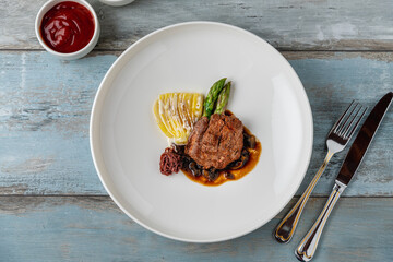 Grilled beef tenderloin with mashed potatoes, vegetables, and sauce
