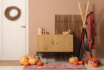 Interior of hallway with autumn decor, door and commode
