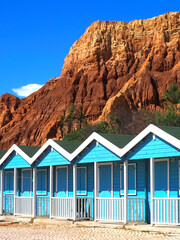 Blue wooden fishing huts or houses at the beach of Olhos de agua Algarve Portugal
