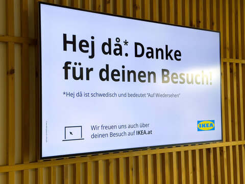 Ikea store signage in german and swedish displayed on wooden wall