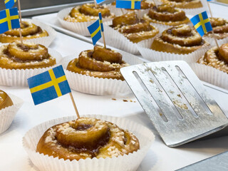 Swedish cinnamon buns with flags displayed in bakery