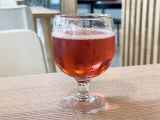 Chilled rosé wine glass on wooden table in modern cafe setting