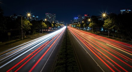 Laptop desk lamp plant and books on a white surface against a gray wall.