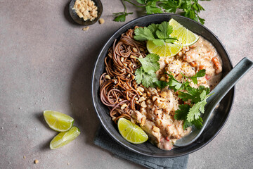 Creamy Asian noodles with chicken, peanuts, and fresh herbs.