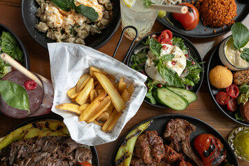 Mixed grill with salads and fries.