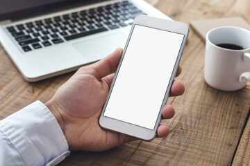 Latin indian adult student holding using mock up of cell mobile smartphone with empty blank white screen for advertising. Over shoulder closeup view.
