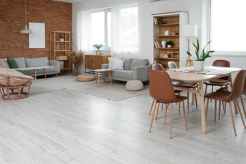 Interior of studio apartment with sofas, dining table and shelf units