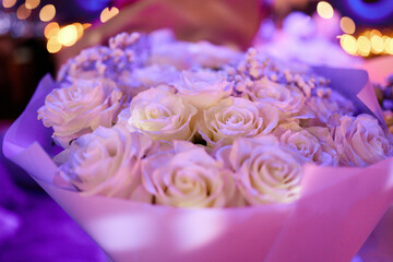White roses bouquet glowing in neon light