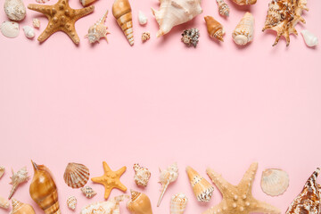 Many different seashells and starfishes on pink background