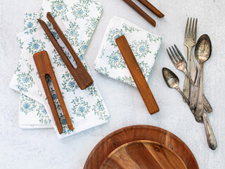Table linens and napkins with napkin holders plates cutlery top view tablescape