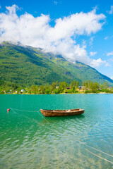 Wooden boat on a mountain lake in a Norwegian fjord. Nature in fjords. High mountains and...