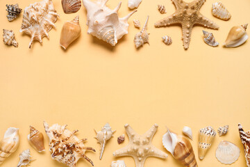 Many different seashells and starfishes on yellow background