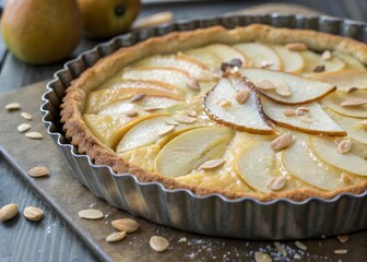 Baking pear tart in vintage fluted pan with almond cream rustic kitchen dessert recipe warm atmosphere close-up tarte bourdaloue