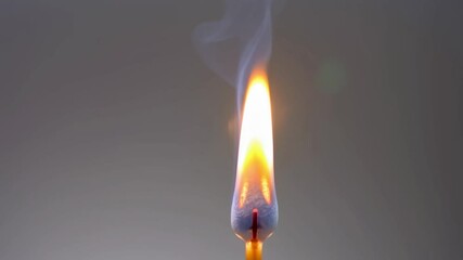 Photo of a burning matchstick, orange, yellow, and blue, representing fire and ignition with copy space