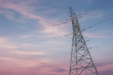 High voltage cables and transmission towers, isolated against a stunning sky