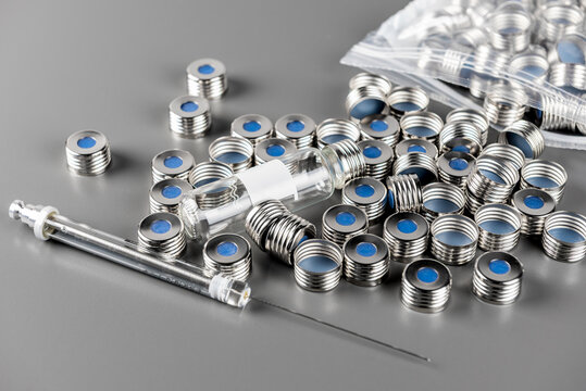 HPLC, gas chromatography measuring, vials and syringe for autosampler. circular metallic cap with rubber septum for vials.