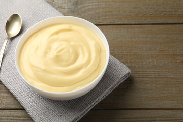 Tasty vanilla pudding served on wooden table, closeup. Space for text