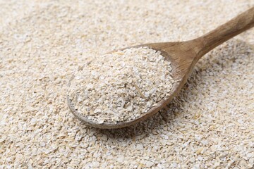 Superfood product. Oat powder and spoon as background, closeup