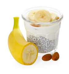 Delicious dessert with chia seeds, yogurt, banana and almond in glass on white background. Superfood