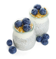 Delicious pudding with chia seeds, yogurt, blueberries and granola in glasses isolated on white. Superfood