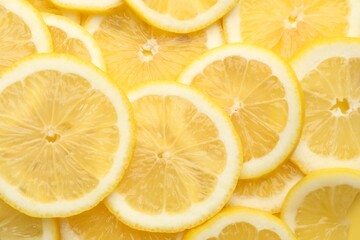 Slices of fresh lemons as background, top view