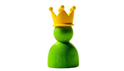 Green figurine with golden crown. Success concept