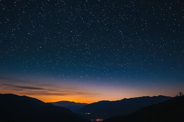 Starry night sky over silhouetted mountains at sunset, a breathtaking celestial view.