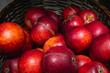 Vibrant colorful red apples in a basket.