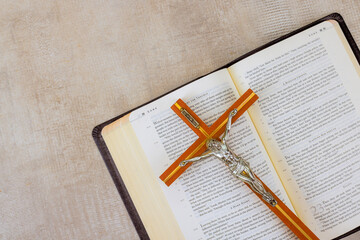 24 April 2025 Washington DC US Crucifix rests on an open Bible, symbolizing faith, spirituality in...