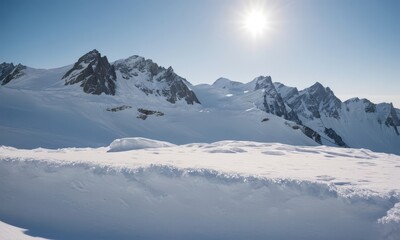Fototapeta premium Majestic snowy mountain peaks under clear skies illuminated by the sun