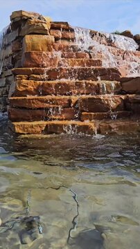 Brick waterfall landscape feature with water cascading