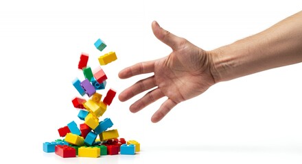 Stopping Cascade of Colorful Toy Bricks with Hand Isolated Against White Backdrop Featuring Red Blue Yellow and Green Plastic Blocks Ideal For Creative and Educational Themes