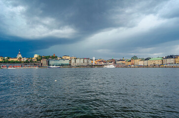 Fototapeta premium Urban scene in Stockholm, Sweden with storm clouds in the background