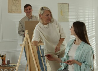 Artist and her students having painting class in studio