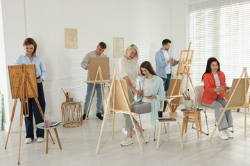 Artist and her students having painting class in studio