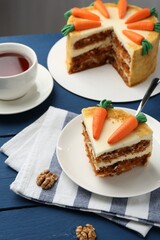 Delicious homemade carrot cake served on blue wooden table