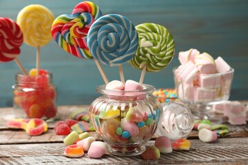 Many different tasty candies on wooden table