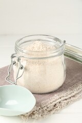 Brown rice flour on white table, closeup