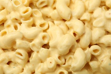 Delicious pasta with cheese sauce as background, top view