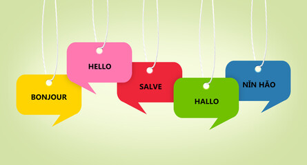 Paper speech bubbles with greetings in different languages hanging on light sage color background. Banner design © New Africa