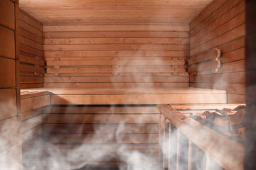 Wooden sauna with bench and hot stones in steam