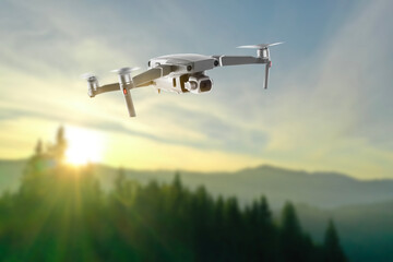 Drone with camera flying in mountains. Unmanned aerial vehicle for surveillance