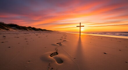 Cross on beach at sunset christian faith religion spiritual hope jesus christ footprints sand ocean sky