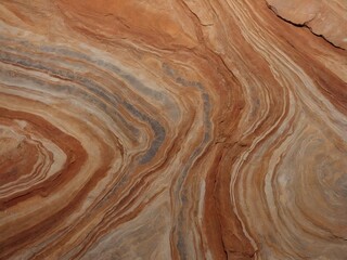 Fototapeta premium Rock texture featuring swirling layers of red, brown, and grey sandstone