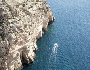 Pleasure Boat Along Cliffs of Valletta Malta