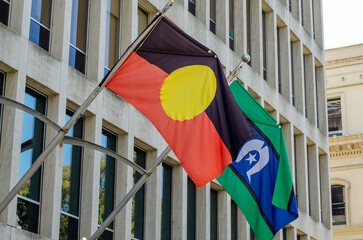 The Aboriginal flag and Torres Strait Islander flag fly together on an office building in an...
