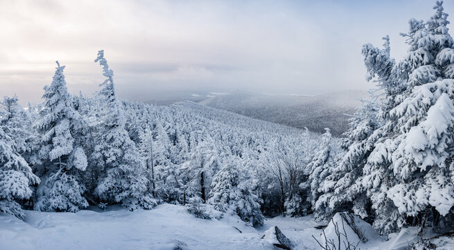 Panoramic, frozen and snow covered landscape in the morning from the summit of St-Joseph mountain on a cold winter day, Megantic national park, Qc, Canada