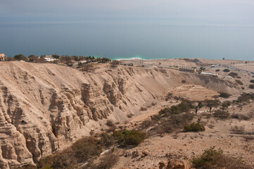 A beach with a rocky cliff in the background