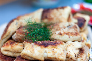 A plate of food with a green herb on top